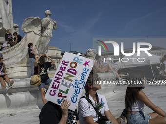 A person holds a sign with the text ''Gender Splendor for Everyone'' during the first gender liberation march at Union Station in Washington...