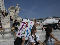 A person holds a sign with the text ''Gender Splendor for Everyone'' during the first gender liberation march at Union Station in Washington...