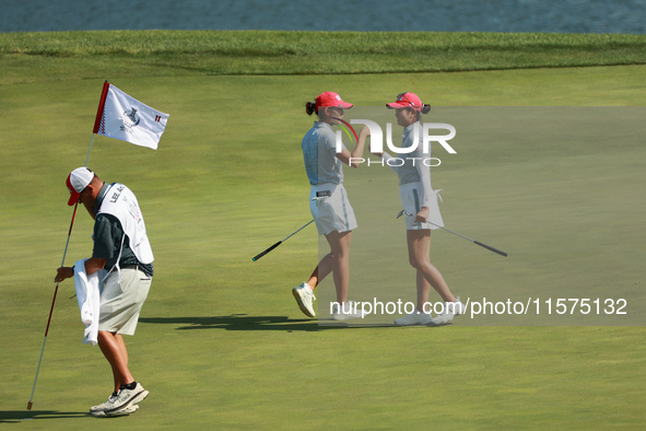 GAINESVILLE, VIRGINIA - SEPTEMBER 14: Rose Zhang of the United States (R) celebrates her putt on the 11th green with teammate Andrea Lee (L)...