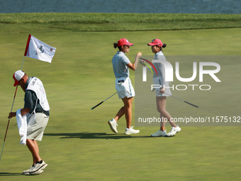 GAINESVILLE, VIRGINIA - SEPTEMBER 14: Rose Zhang of the United States (R) celebrates her putt on the 11th green with teammate Andrea Lee (L)...