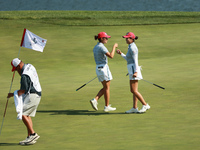 GAINESVILLE, VIRGINIA - SEPTEMBER 14: Rose Zhang of the United States (R) celebrates her putt on the 11th green with teammate Andrea Lee (L)...