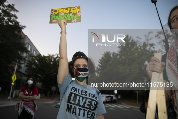 A person holds a sign with the text ''Jew for Palestine'' and poses for a photograph during a pro-Palestinian rally in front of the Israeli...