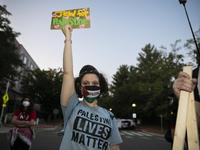 A person holds a sign with the text ''Jew for Palestine'' and poses for a photograph during a pro-Palestinian rally in front of the Israeli...