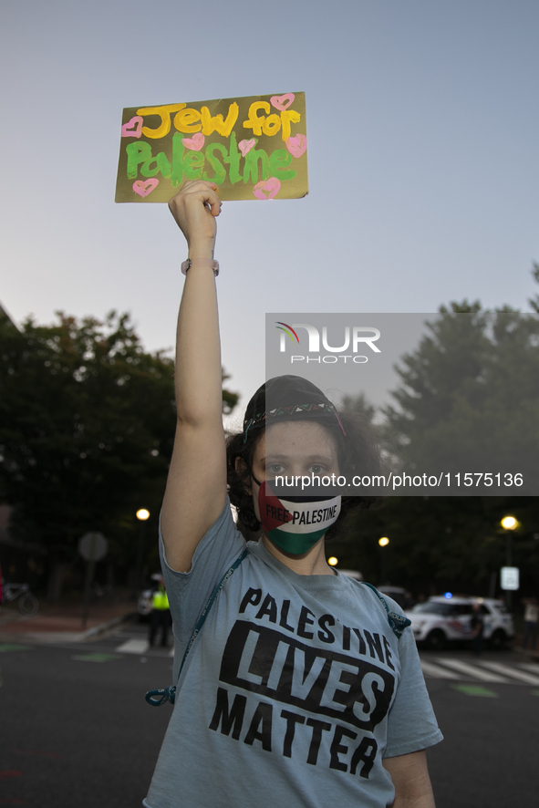 A person holds a sign with the text ''Jew for Palestine'' and poses for a photograph during a pro-Palestinian rally in front of the Israeli...