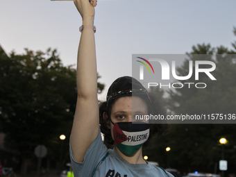 A person holds a sign with the text ''Jew for Palestine'' and poses for a photograph during a pro-Palestinian rally in front of the Israeli...