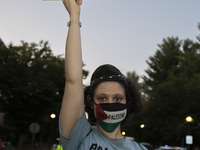 A person holds a sign with the text ''Jew for Palestine'' and poses for a photograph during a pro-Palestinian rally in front of the Israeli...