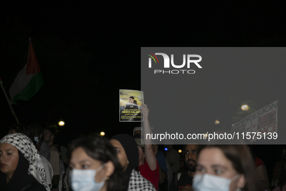 A person holds an image of Palestinian social media personality Medo Halimy during a pro-Palestinian rally in front of the Israeli Embassy i...