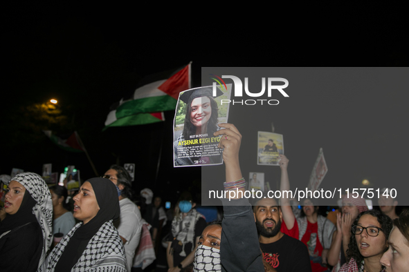 A person holds an image of Turkish-American human rights activist Aysenur Ezgi Eygi during a pro-Palestinian rally in front of the Israeli E...