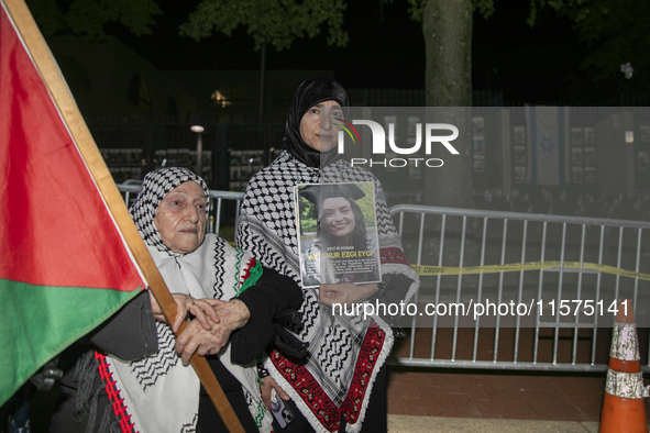 A person holds an image of Turkish-American human rights activist Aysenur Ezgi Eygi during a pro-Palestinian rally in front of the Israeli E...