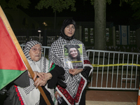 A person holds an image of Turkish-American human rights activist Aysenur Ezgi Eygi during a pro-Palestinian rally in front of the Israeli E...