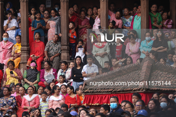 Revelers watch the sacred pole Ya:shi erection procession at Kathmandu Durbar Square in Kathmandu, Nepal, on September 15, 2024, ahead of th...