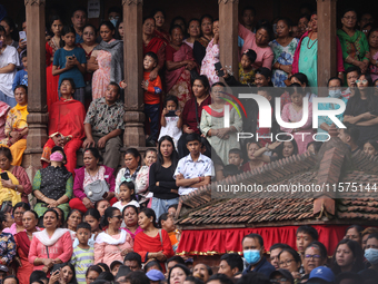 Revelers watch the sacred pole Ya:shi erection procession at Kathmandu Durbar Square in Kathmandu, Nepal, on September 15, 2024, ahead of th...