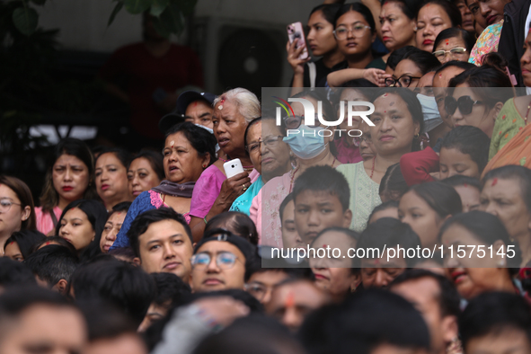 Revelers watch the sacred pole Ya:shi erection procession at Kathmandu Durbar Square in Kathmandu, Nepal, on September 15, 2024, ahead of th...