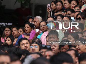 Revelers watch the sacred pole Ya:shi erection procession at Kathmandu Durbar Square in Kathmandu, Nepal, on September 15, 2024, ahead of th...