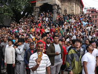 Revelers watch the sacred pole Ya:shi erection procession at Kathmandu Durbar Square in Kathmandu, Nepal, on September 15, 2024, ahead of th...