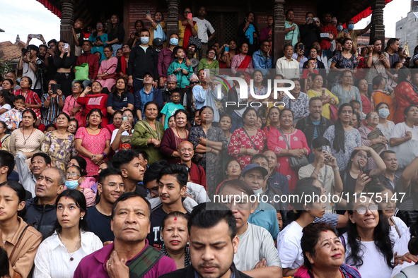 Revelers watch the sacred pole Ya:shi erection procession at Kathmandu Durbar Square in Kathmandu, Nepal, on September 15, 2024, ahead of th...