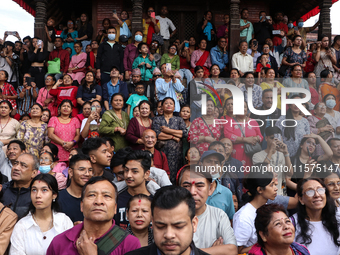 Revelers watch the sacred pole Ya:shi erection procession at Kathmandu Durbar Square in Kathmandu, Nepal, on September 15, 2024, ahead of th...