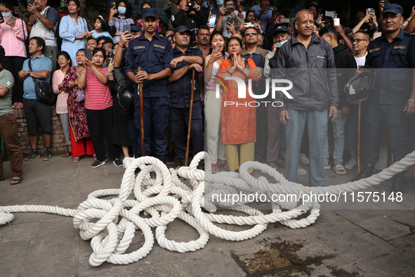 Revelers watch the sacred pole Ya:shi erection procession at Kathmandu Durbar Square in Kathmandu, Nepal, on September 15, 2024, ahead of th...