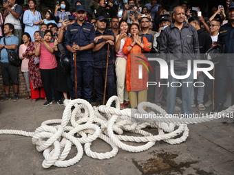 Revelers watch the sacred pole Ya:shi erection procession at Kathmandu Durbar Square in Kathmandu, Nepal, on September 15, 2024, ahead of th...