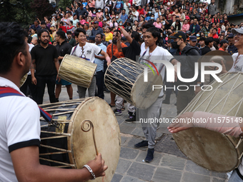 Nepali Hindu devotees play musical instruments as they erect a sacred pole locally called ''Ya:Shi,'' marking the formal start of Indra Jatr...