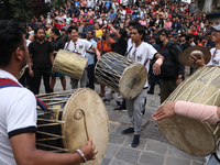 Nepali Hindu devotees play musical instruments as they erect a sacred pole locally called ''Ya:Shi,'' marking the formal start of Indra Jatr...