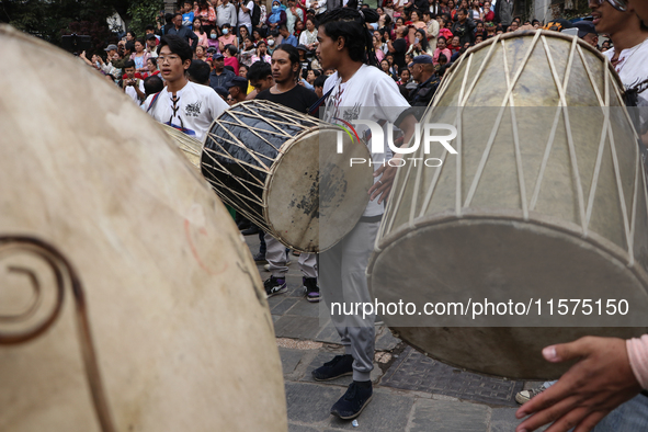 Nepali Hindu devotees play musical instruments as they erect a sacred pole locally called ''Ya:Shi,'' marking the formal start of Indra Jatr...