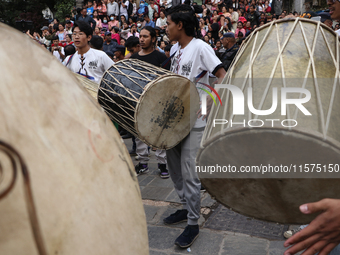 Nepali Hindu devotees play musical instruments as they erect a sacred pole locally called ''Ya:Shi,'' marking the formal start of Indra Jatr...