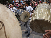 Nepali Hindu devotees play musical instruments as they erect a sacred pole locally called ''Ya:Shi,'' marking the formal start of Indra Jatr...