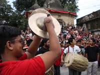 Nepali Hindu devotees play musical instruments as they erect a sacred pole locally called ''Ya:Shi,'' marking the formal start of Indra Jatr...