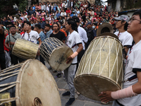 Nepali Hindu devotees play musical instruments as they erect a sacred pole locally called ''Ya:Shi,'' marking the formal start of Indra Jatr...