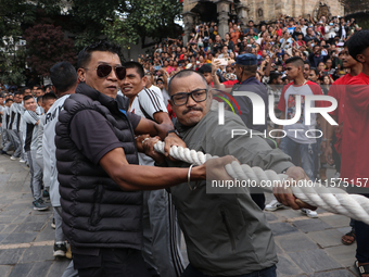 Nepali Hindu devotees pull the sacred pole locally called ''Ya:Shi,'' marking the formal start of Indra Jatra, a fair dedicated to the Hindu...