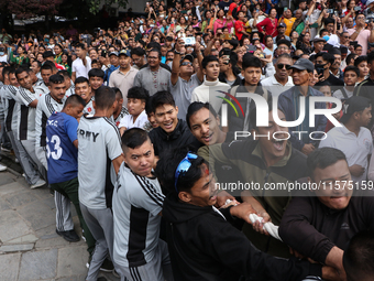 Nepali Hindu devotees pull the sacred pole locally called ''Ya:Shi,'' marking the formal start of Indra Jatra, a fair dedicated to the Hindu...