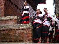 Nepali girls in Newari attire watch the sacred pole-Ya:shi erection procession at Kathmandu Durbar Square in Kathmandu, Nepal, on September...