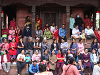 Nepali revelers sit on the stairs of a temple to watch the procession of erecting a sacred pole locally called ''Ya: Shi,'' marking the form...