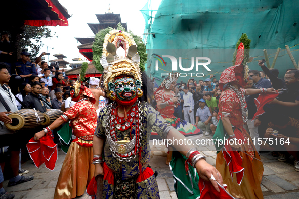 Masked dancers perform a ritualistic dance at Kathmandu Durbar Square during the procession of erecting a sacred pole locally called ''Ya: S...