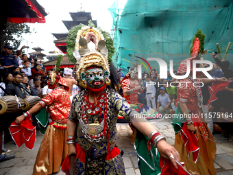 Masked dancers perform a ritualistic dance at Kathmandu Durbar Square during the procession of erecting a sacred pole locally called ''Ya: S...