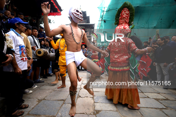 Masked dancers perform a ritualistic dance at Kathmandu Durbar Square during the procession of erecting a sacred pole locally called ''Ya: S...