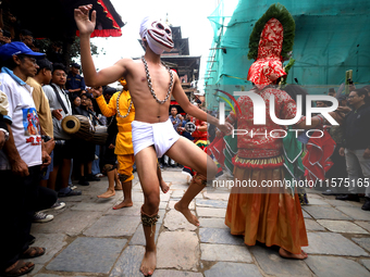 Masked dancers perform a ritualistic dance at Kathmandu Durbar Square during the procession of erecting a sacred pole locally called ''Ya: S...