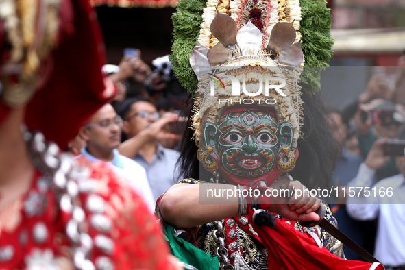 Masked dancers perform a ritualistic dance at Kathmandu Durbar Square during the procession of erecting a sacred pole locally called ''Ya: S...