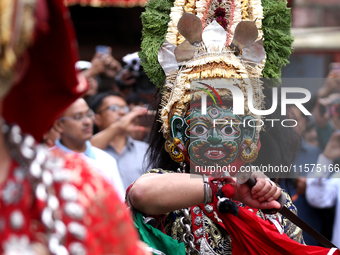 Masked dancers perform a ritualistic dance at Kathmandu Durbar Square during the procession of erecting a sacred pole locally called ''Ya: S...