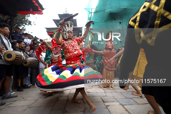 Masked dancers perform a ritualistic dance at Kathmandu Durbar Square during the procession of erecting a sacred pole locally called ''Ya: S...