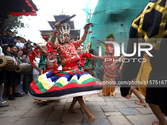 Masked dancers perform a ritualistic dance at Kathmandu Durbar Square during the procession of erecting a sacred pole locally called ''Ya: S...