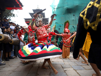 Masked dancers perform a ritualistic dance at Kathmandu Durbar Square during the procession of erecting a sacred pole locally called ''Ya: S...