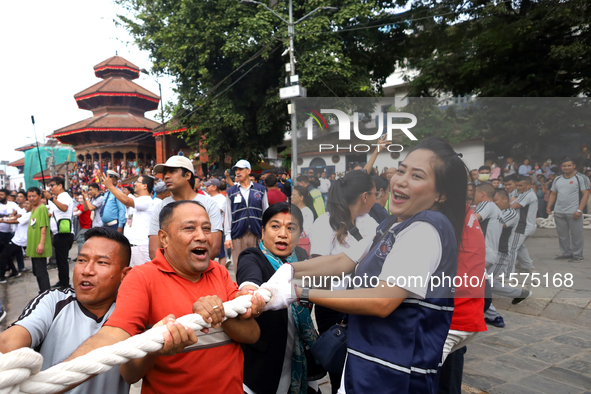 Nepali Hindu devotees pull a sacred pole locally called ''Ya: Shi,'' marking the formal start of Indra Jatra dedicated to the rain god Indra...