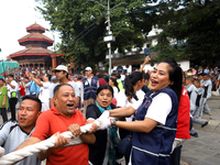 Nepali Hindu devotees pull a sacred pole locally called ''Ya: Shi,'' marking the formal start of Indra Jatra dedicated to the rain god Indra...