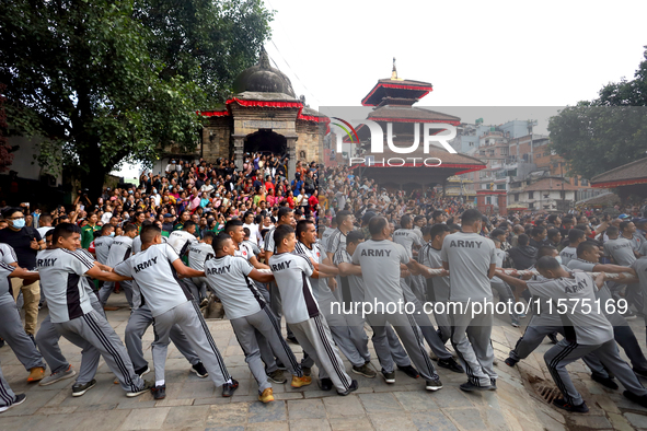 Nepali Hindu devotees pull a sacred pole locally called ''Ya: Shi,'' marking the formal start of Indra Jatra dedicated to the rain god Indra...