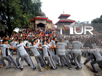 Nepali Hindu devotees pull a sacred pole locally called ''Ya: Shi,'' marking the formal start of Indra Jatra dedicated to the rain god Indra...