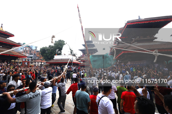 Nepali Hindu devotees pull a sacred pole locally called ''Ya: Shi,'' marking the formal start of Indra Jatra dedicated to the rain god Indra...