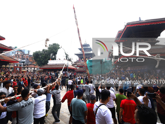 Nepali Hindu devotees pull a sacred pole locally called ''Ya: Shi,'' marking the formal start of Indra Jatra dedicated to the rain god Indra...