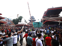 Nepali Hindu devotees pull a sacred pole locally called ''Ya: Shi,'' marking the formal start of Indra Jatra dedicated to the rain god Indra...